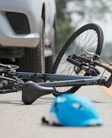 bike fallen on the floor with a bike in the background 