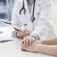 Doctor holding a patient's hand