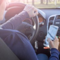 a person holding a phone in a car