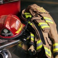 firefighter jacket and helmet laying on a truck