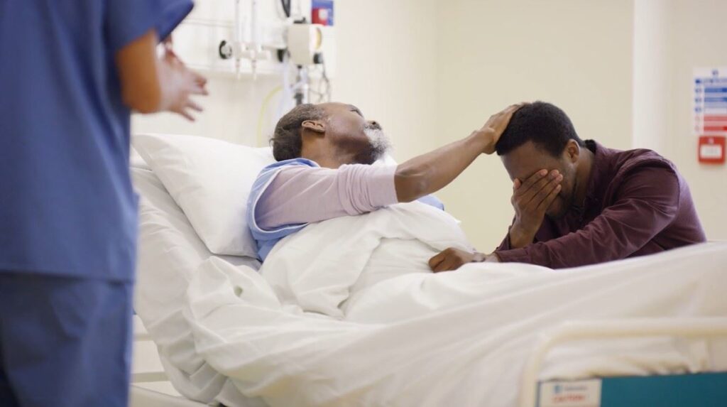a man lying in a hospital bed
