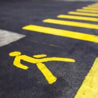 Crossing walk sign painted on the asphalt 