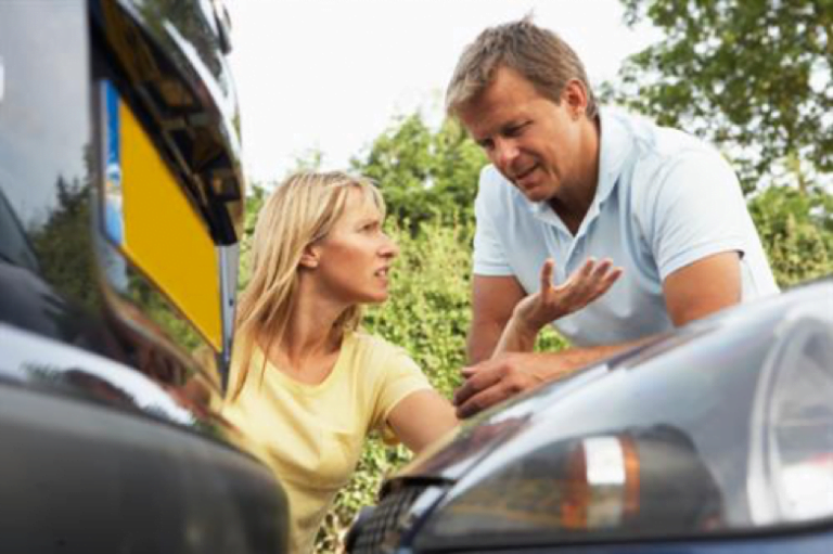 Woman and a man arguing about a car accident