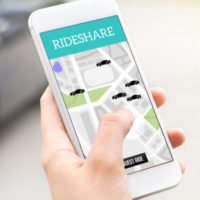 person holding phone on a rideshare app