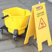 A caution sign with a mop bucket