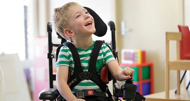 a boy sitting in a chair