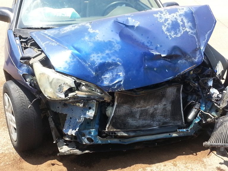 a blue car with a smashed front end