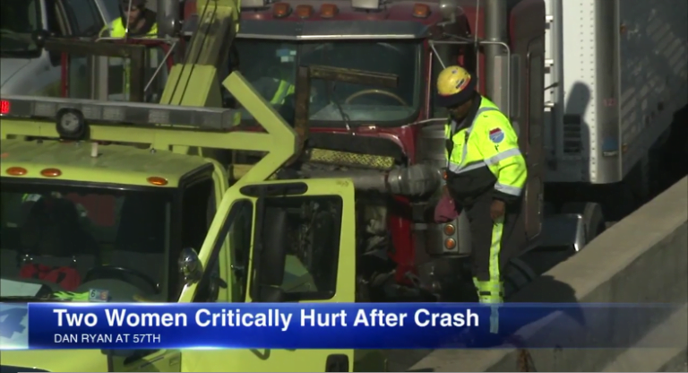 Tow truck towing away a big rig on the news 