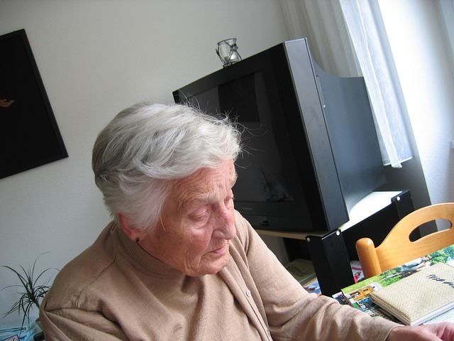 Elderly woman sitting at a desk