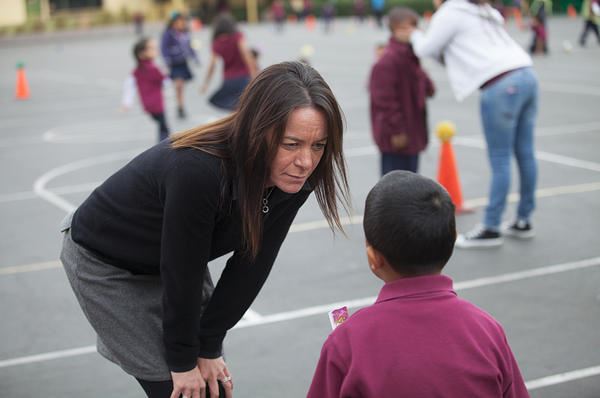 Older woman talking to a child on the playground