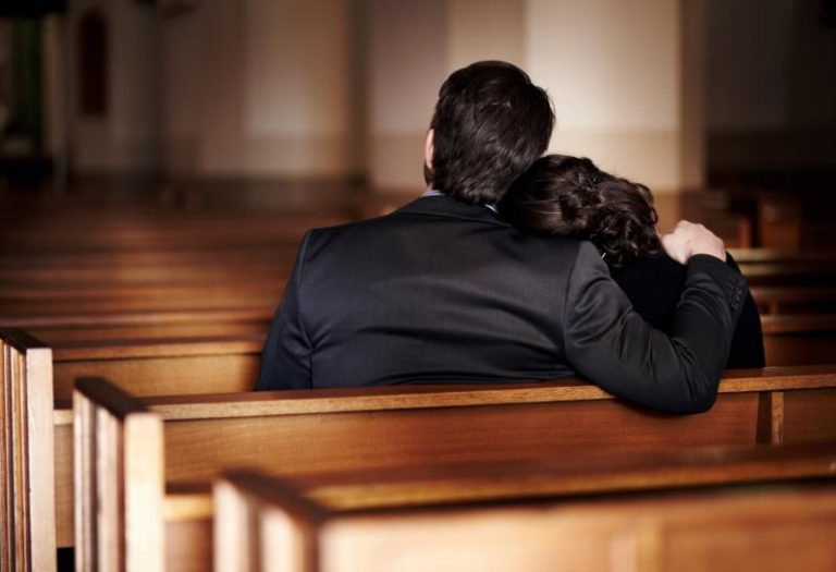 a man and woman sitting on a bench