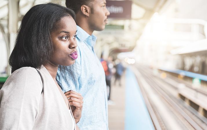a woman looking at a train