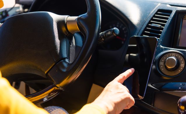 a hand holding a steering wheel