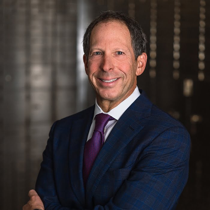 Jonathan Walner in a suit smiling