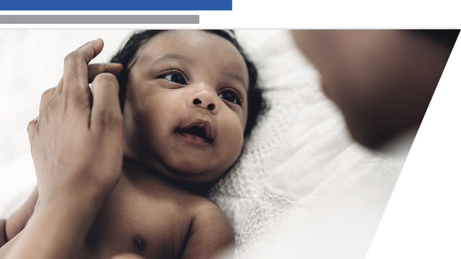 a baby with mothers hand on its head