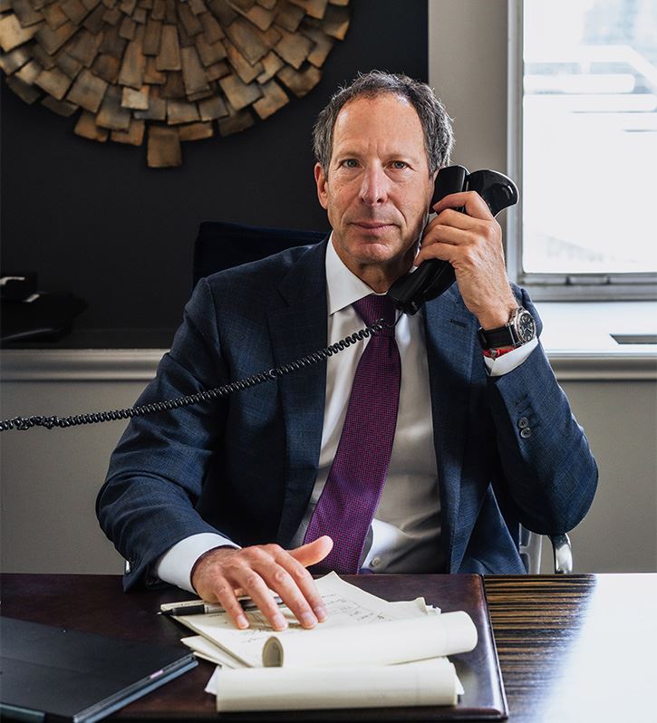 a man in a suit and tie holding a telephone