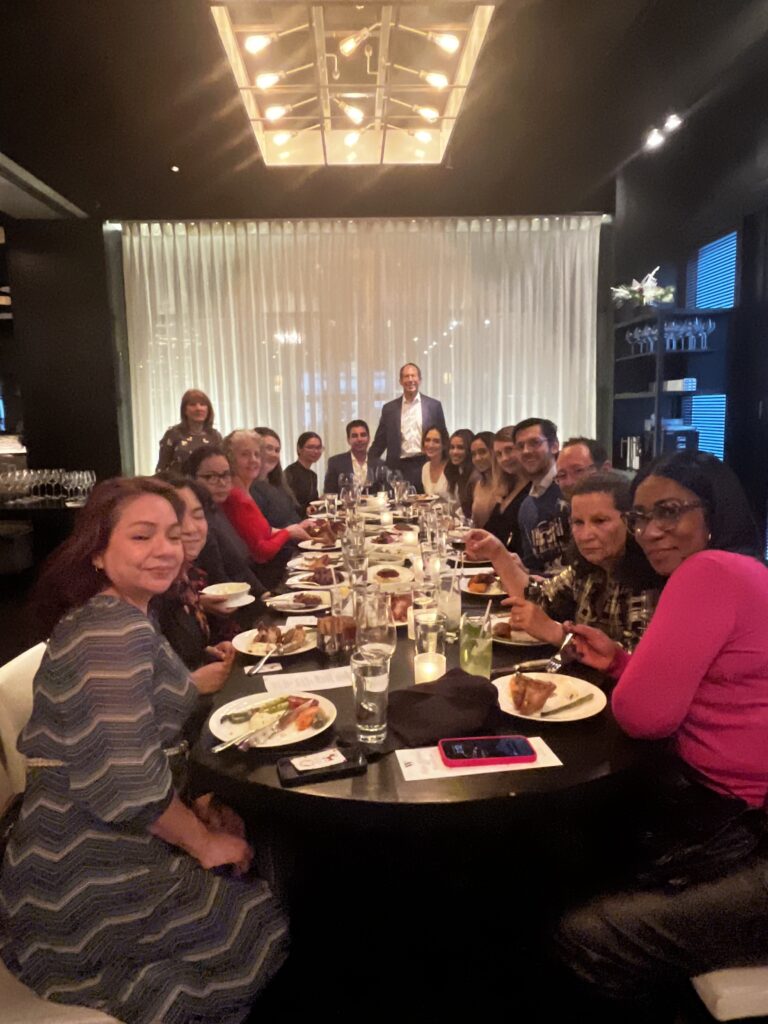 a group of people sitting at a table with food