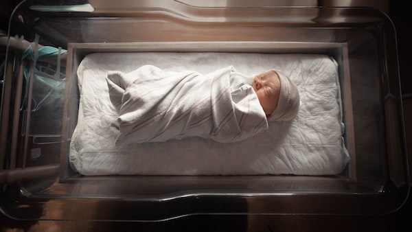 Newborn baby wrapped in a swaddle at a hospital suffered a birth injury and requires a Chicago medical malpractice lawyer