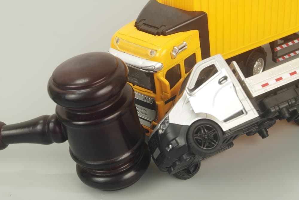 Gavel & two accident trucks - Concept of Truck Accident