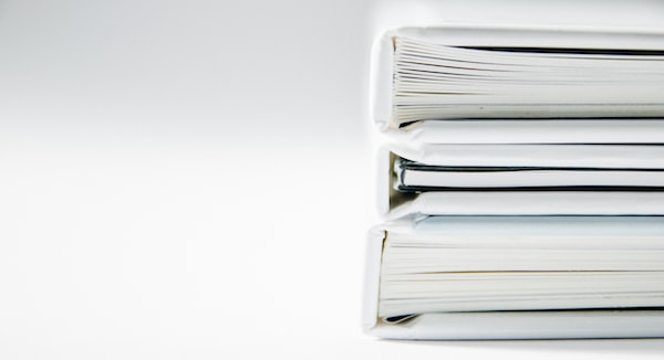 Three binders full of paperwork stacked on top of each other at a Chicago motorcycle accident attorney's office