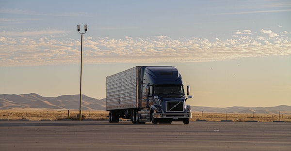 A semi-truck parked in a lot while the driver reaches out to the best truck accident lawyers in Chicago