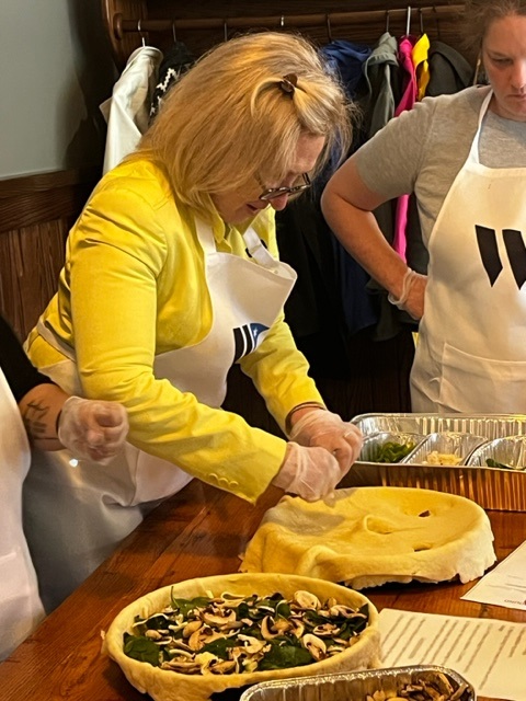 a woman in a yellow apron preparing food