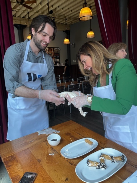 a man and a woman cutting a cake