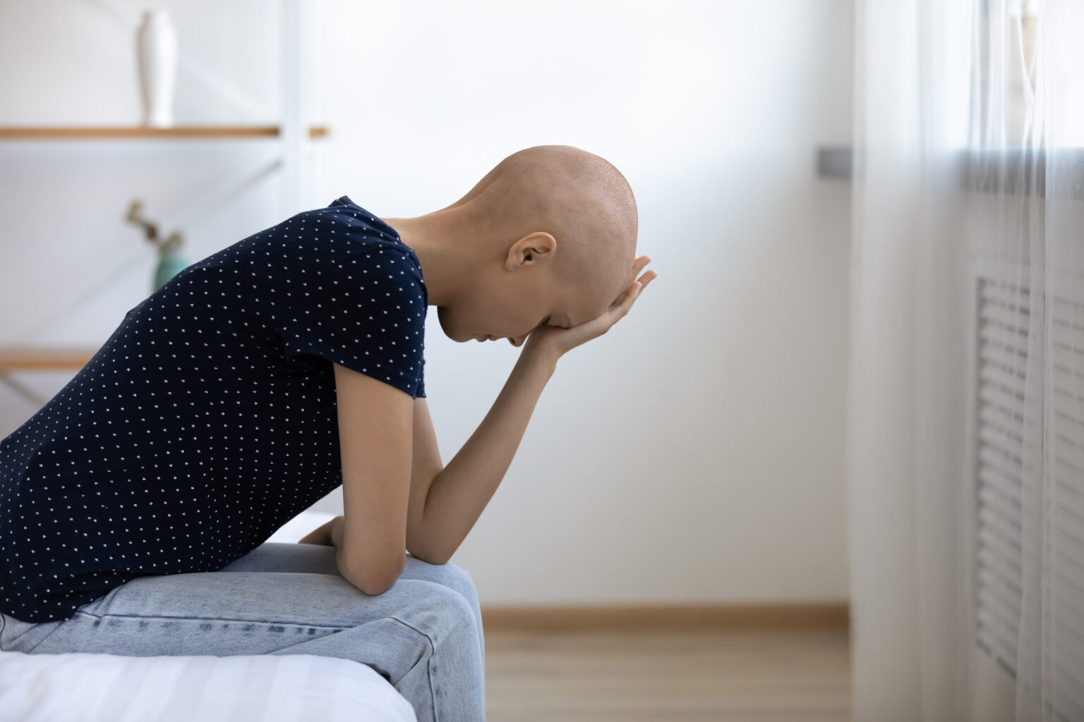 Depressed young bald cancer ill woman feeling unwell.