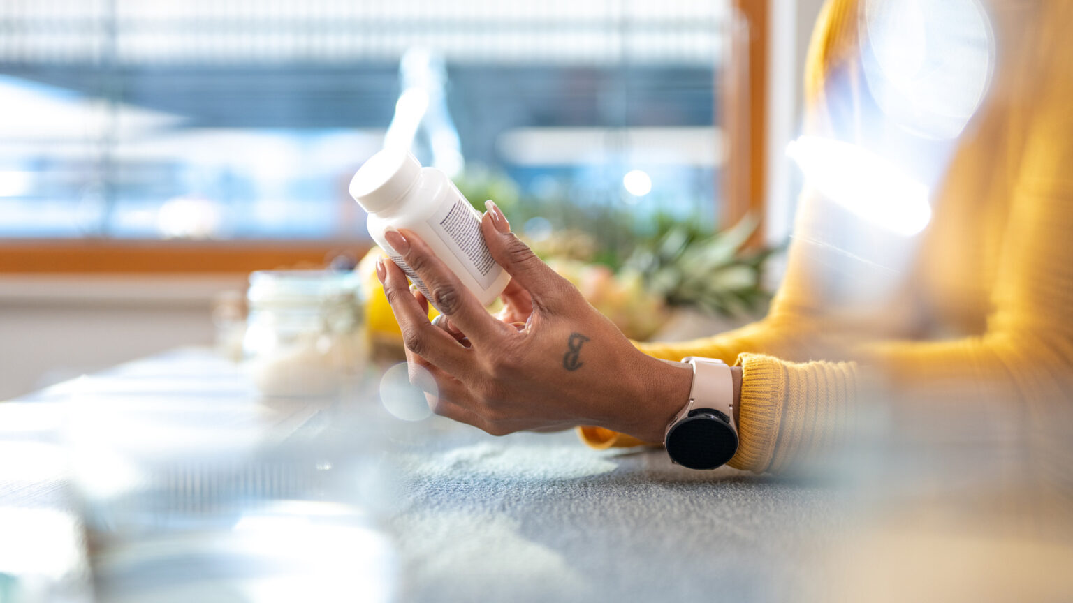 Female hands holding vitamin and reading instruction