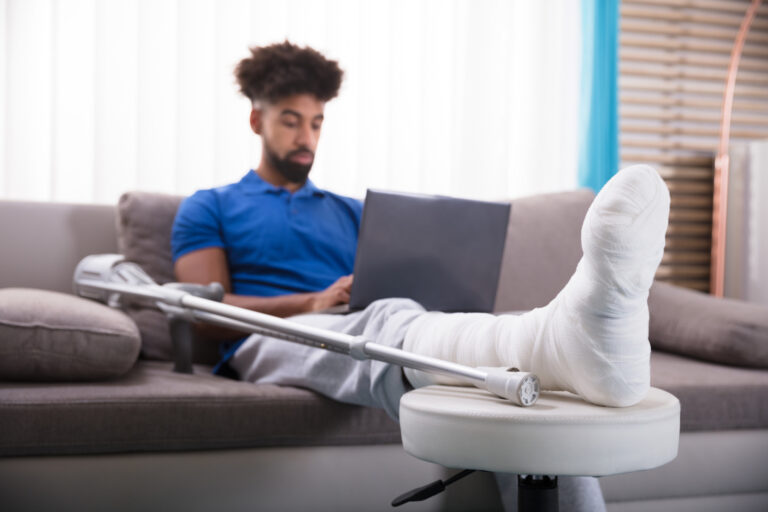 Injured man on Laptop