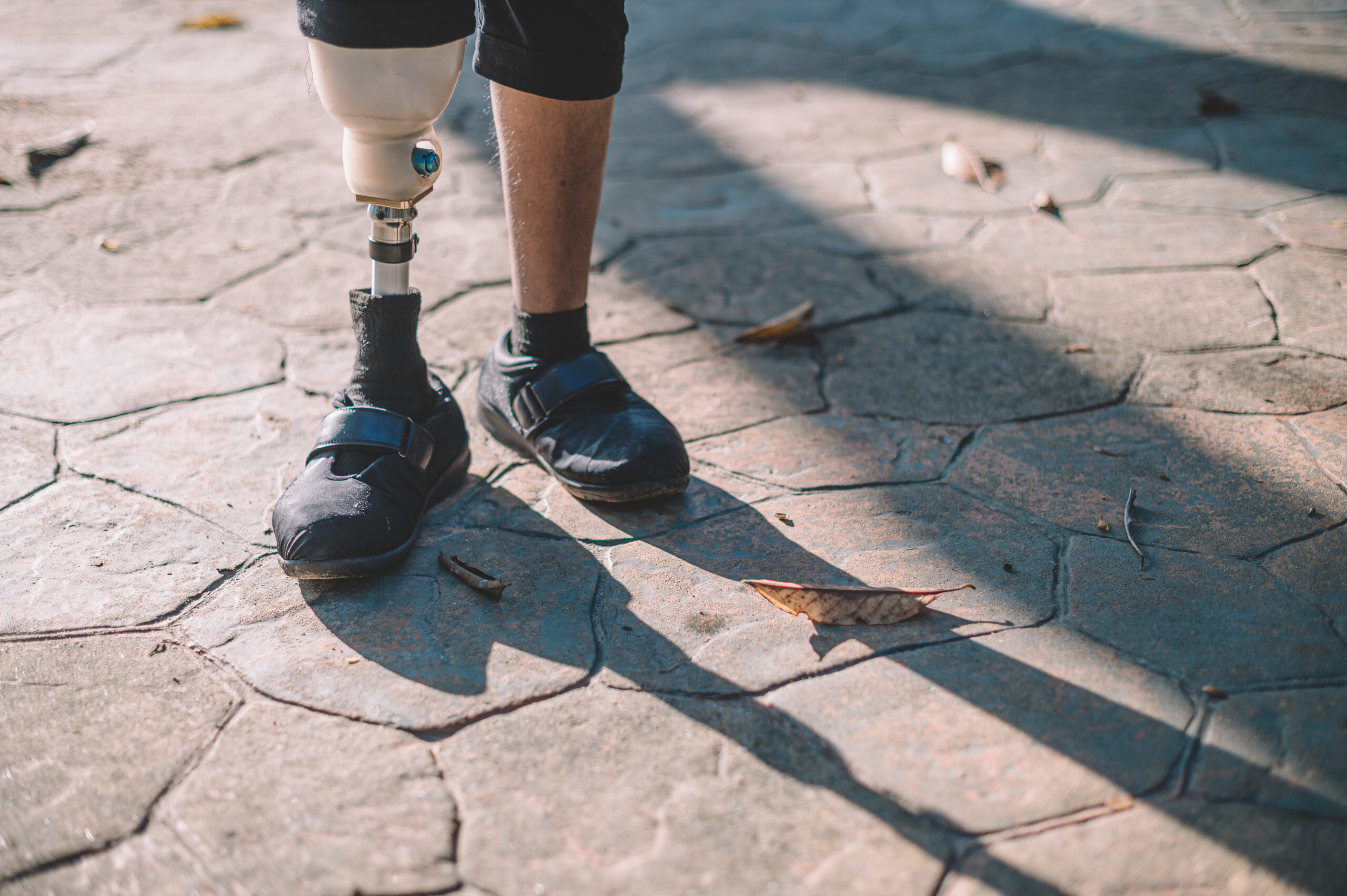 a person's legs and feet on a sidewalk