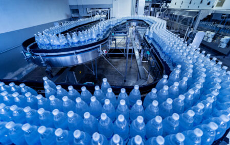 a large metal structure with blue water