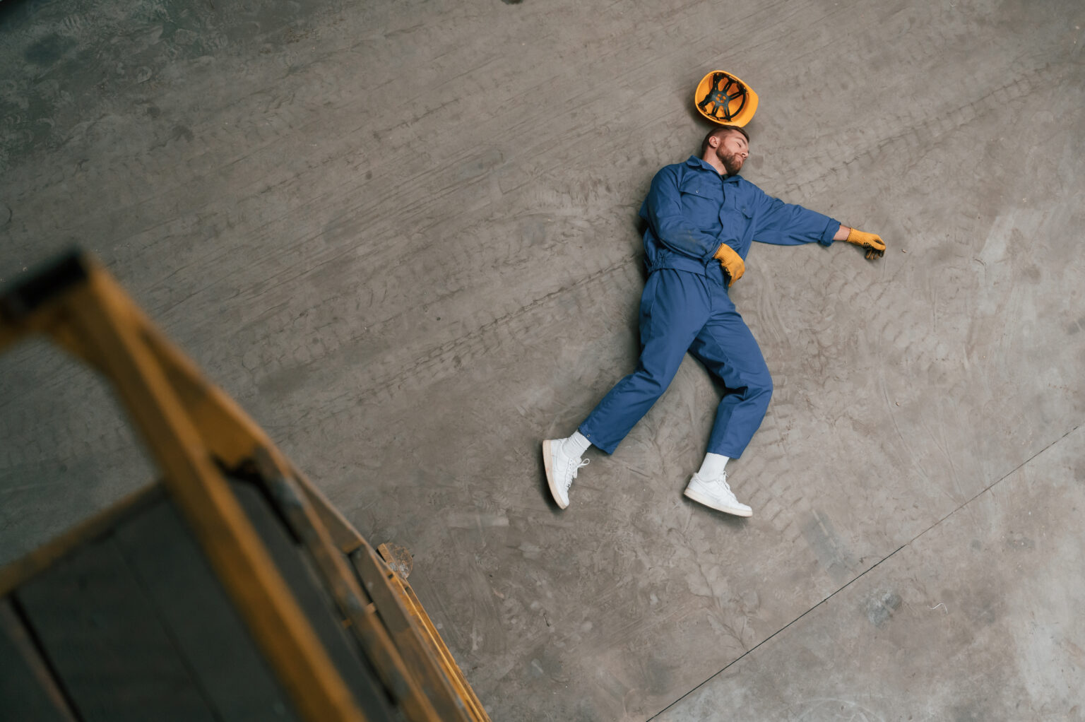 Top view of dead factory worker that lying on the floor