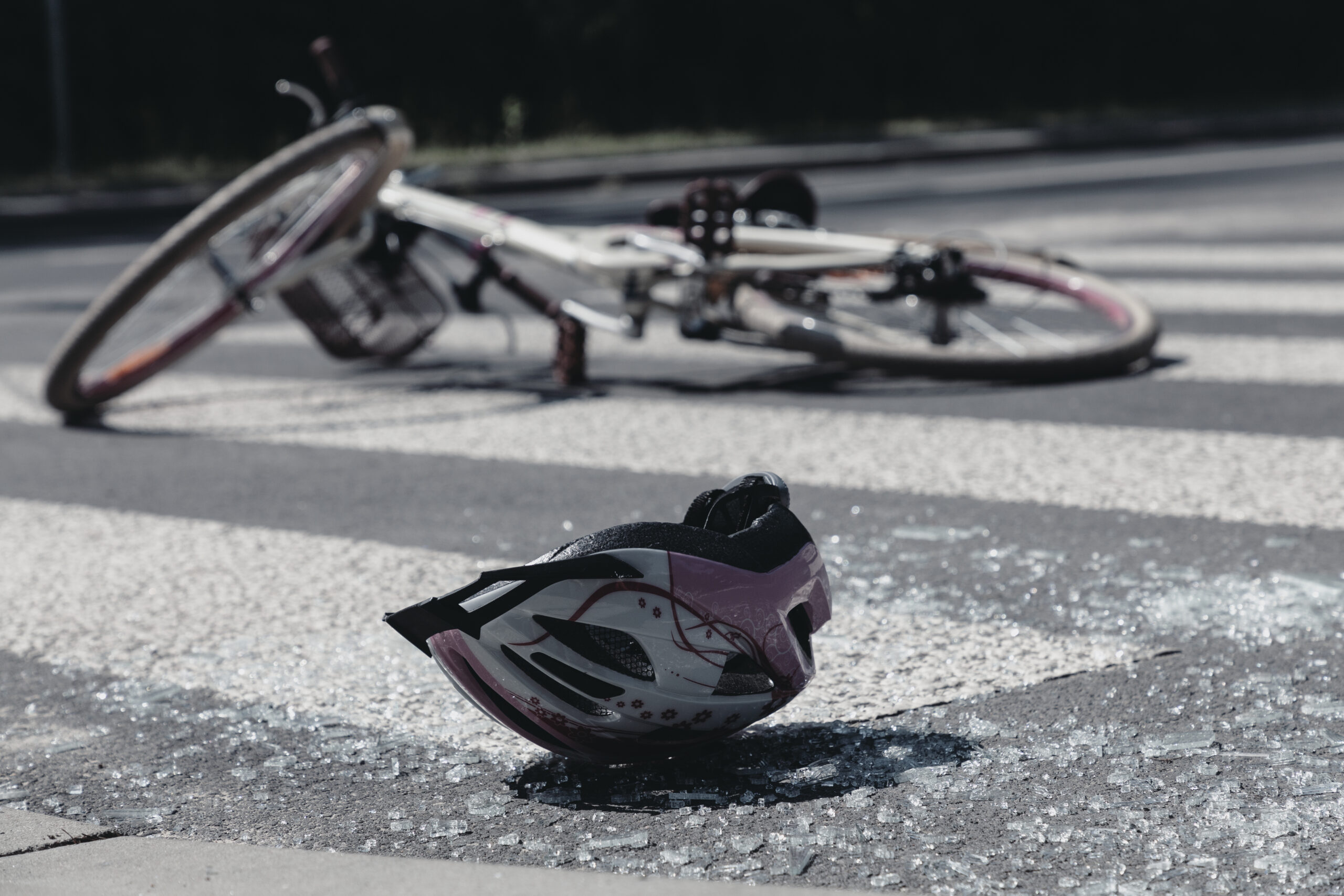 Broken child's helmet and bike on pedestrian cross