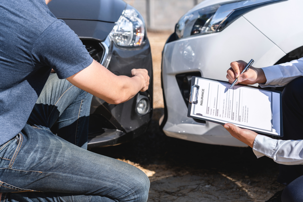 Lawyer reviews accident report with client, working to prove negligence in an Illinois car crash case.