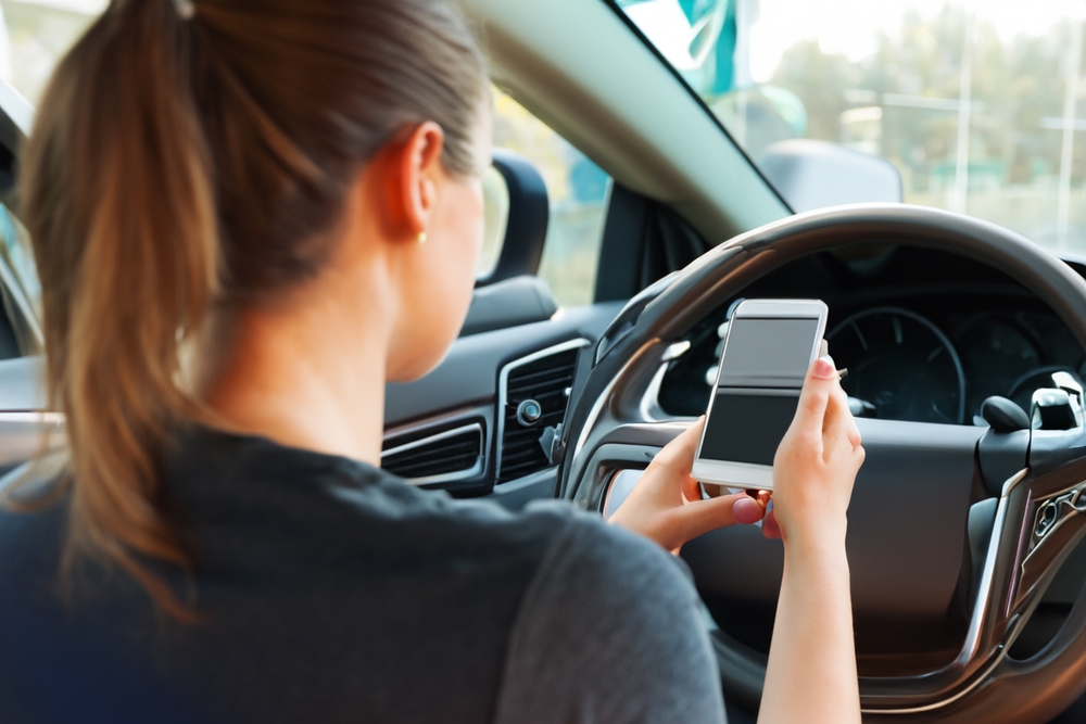 Speeding car weaves through traffic on highway, illustrating a common example of reckless driving behavior.