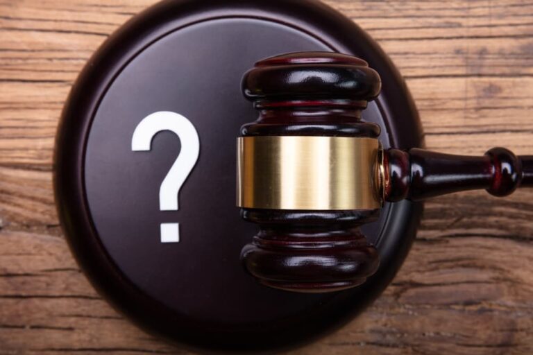 Question Mark and Judge's Gavel on table