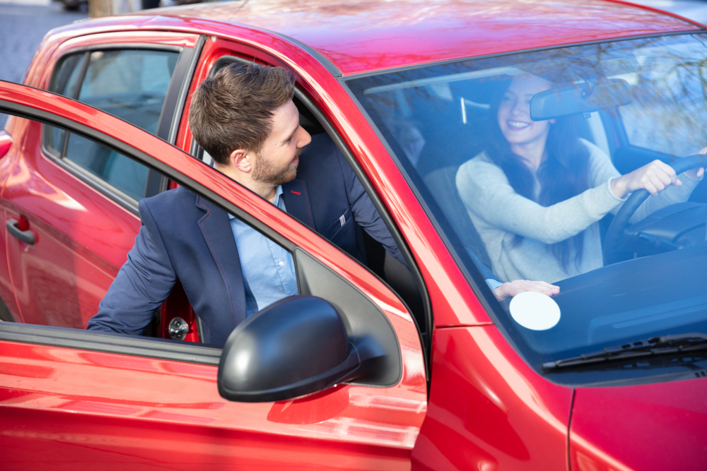 Oblivious car passenger opens door into traffic, creating a dooring hazard