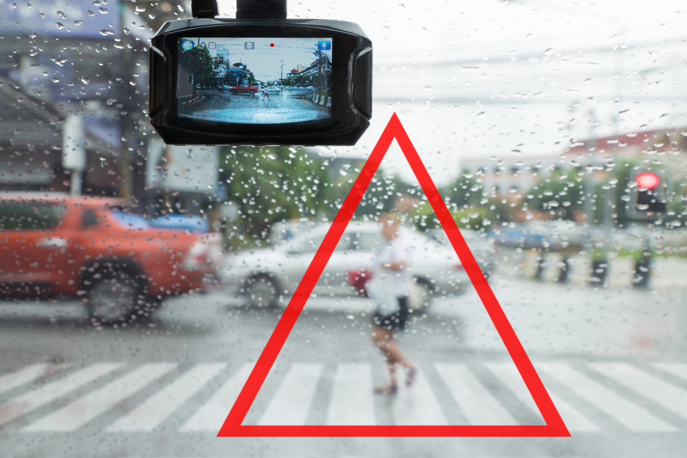 Stylized image of a highlighted pedestrian in view of a car's dash cam
