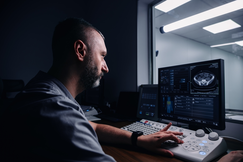 Radiologist reviews cranial scan on computer